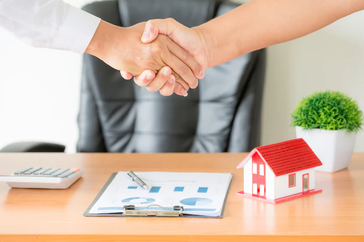 Partnership firm registration - two business partners shaking hands over a signed agreement